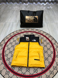 The North Face Puffer Vest in Yellow and Black with Stand Collar