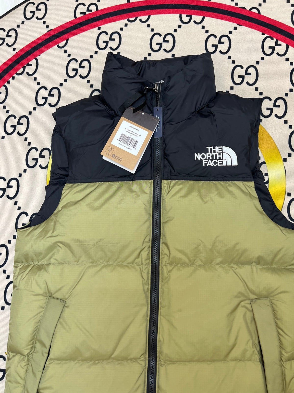The North Face Puffer Vest in Olive Green and Black with Stand Collar