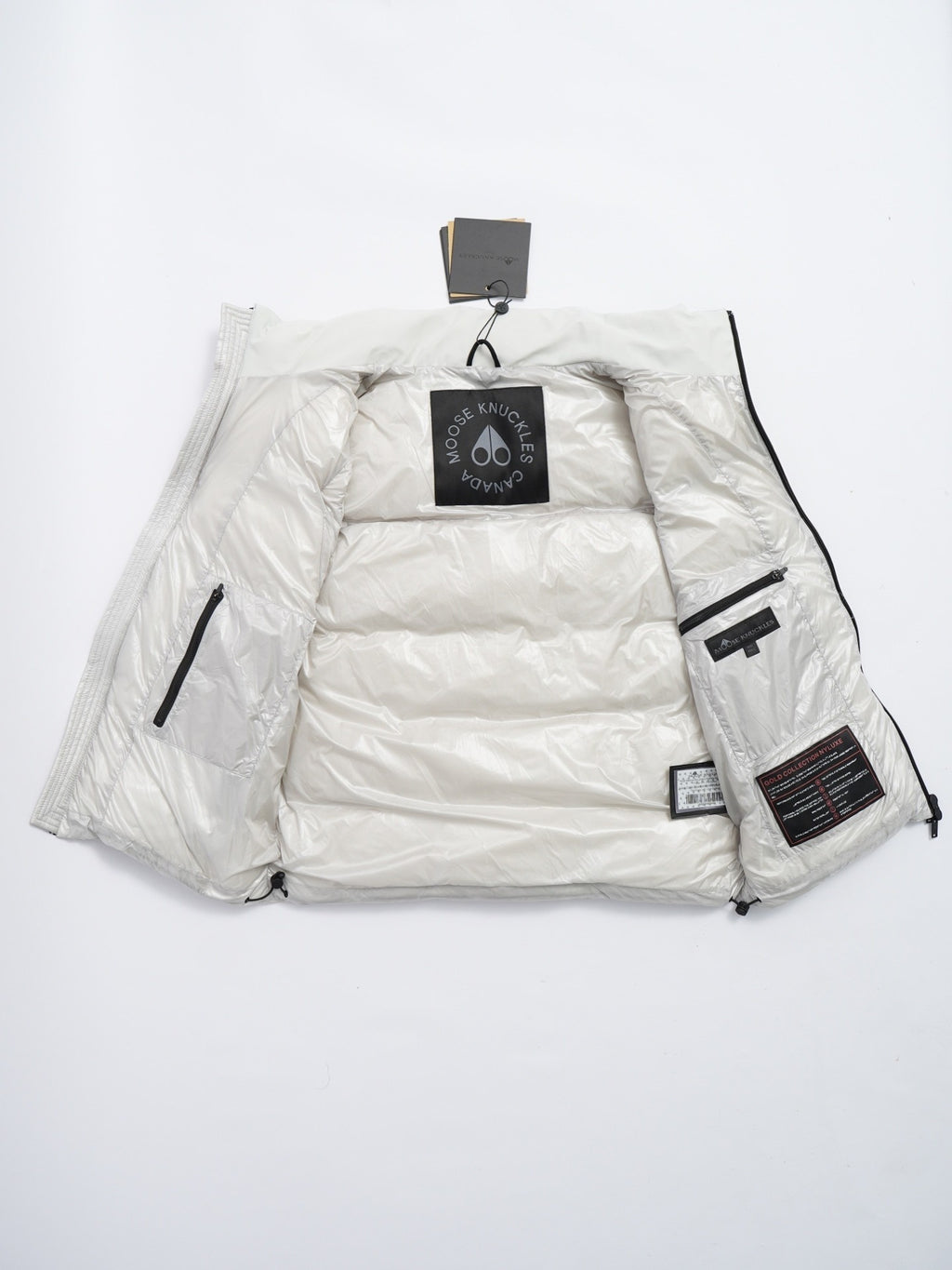 Moose Knuckles Puffer Vest in White with Stand Collar and Metallic Logo